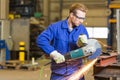 Steel construction worker cutting metal with angle grinder Royalty Free Stock Photo