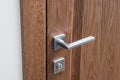 Steel door handle close-up. Dark oak brown colour Royalty Free Stock Photo