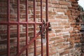 Steel door and key lock and chain with old red brick wall background Royalty Free Stock Photo