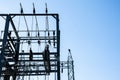 Steel electric poles and lines in High voltage electric power station against sun shine and clear blue sky Royalty Free Stock Photo