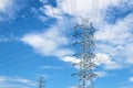 Steel electricity pylon on bright blue sky