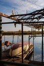 A steel fishing boat, with an onboard serial number, lies on a wooden platform. Royalty Free Stock Photo