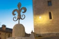 Steel fleur de lys outdoor ornament against blue night sky