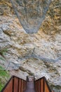 A steel footbridge over a mountain river. A steel mesh protects the passage Royalty Free Stock Photo