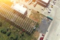 Steel frame construction of modern storage warehouse building at big city suburb. Aerial drone view from above