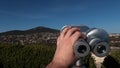 Steel free to use tower viewer binocular scope placed on Nitra castle, with cityscape of Zobor hill and settlements under it.