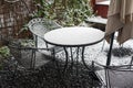 Steel garden table and chairs under the snow