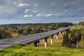 Steel girder bridge on the road that crosses Russian forest.