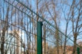 Steel grating fence made with wire on blue sky background. Sectional fencing installation.