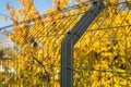 Steel grating fence made with wire on blue sky background. Sectional fencing installation.