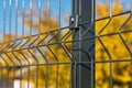 Steel grating fence made with wire on blue sky background. Sectional fencing installation.