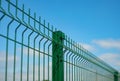 Steel grating fence made with wire on blue sky background. Sectional fencing installation.