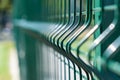 Steel grating fence of soccer field,Metal fence wire with grass in the background Royalty Free Stock Photo