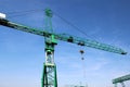Steel green high crane under blue sky Royalty Free Stock Photo