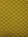 Steel grid on a yellow background Royalty Free Stock Photo