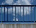 Steel guard rail with vertical pickets and posts along highway