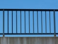 Steel guard rail with pickets and posts on highway with blue sky