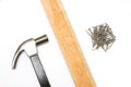 Steel hammer, wooden plate And a pile of nails. Royalty Free Stock Photo