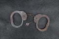 Steel handcuffs lying on the natural leather