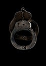 Steel handcuffs of police special equipment, fetters on a black background.