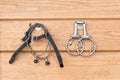 Steel horse snaffle-bit and spurs hanging on wooden background