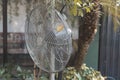 A steel industrial fan at an outdoor al fresco garden event venue