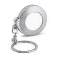 Steel key chain isolated on white background. Blank keyring in measuring tape concept.  Clipping path Royalty Free Stock Photo