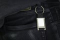 Steel key ring hanging on black jeans. Blank key chain for your design. Souvenir or accessory. Can put text, image, and logo Royalty Free Stock Photo