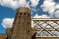 Steel lattice construction of a railway bridge on a background of blue sky with white clouds. Royalty Free Stock Photo