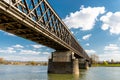 Steel, lattice structure of a railway bridge over a river with a background of blue sky with white clouds in western Germany. Royalty Free Stock Photo