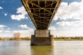 Steel, lattice structure of a railway bridge over a river with a background of blue sky with white clouds in western Germany. Royalty Free Stock Photo