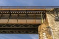 The steel lattice structure of the railway bridge viewed from below against the blue sky. Royalty Free Stock Photo