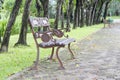 Steel long chair in the park with grass and brick . Royalty Free Stock Photo