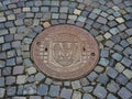 Steel Manhole Cover on Cobble Stone Road, Bucharest, Romania