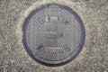 Steel manhole cover or metal sewer on the street in Japan