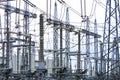 Steel masts of high voltage power lines at the plant. Electrical substation, power converter, high voltage electric Royalty Free Stock Photo