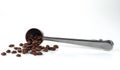 A steel measuring spoon with roasted coffee beans Royalty Free Stock Photo