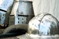 Steel medieval helmets with eyes slits on the table Royalty Free Stock Photo