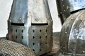 Steel medieval helmets with eyes slits on the table Royalty Free Stock Photo