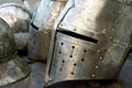 Steel medieval helmets with eyes slits on the table Royalty Free Stock Photo