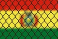 A steel mesh against the background of the flag Bolivia.