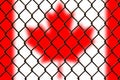 A steel mesh against the background of the flag Canada. Royalty Free Stock Photo