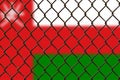 A steel mesh against the background of the flag Oman. Royalty Free Stock Photo