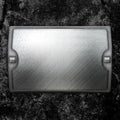 Steel metal plate on concrete wall Royalty Free Stock Photo