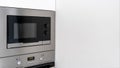 Steel microwave with time display in kitchen Royalty Free Stock Photo