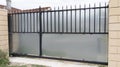 Steel modern closed new metal gate house portal of suburb home door