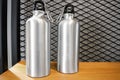 Steel mug on white shelf. Blank stainless tumbler for your design. Insulated bottle for keep your drink