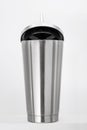 Steel mug on white shelf. Blank stainless tumbler for your design. Insulated bottle for keep your drink