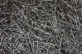 Steel nails lie in a pile close-up. rough surface texture Royalty Free Stock Photo