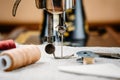 Steel needle with looper and a presser foot of old vintage hand sewing machine close-up Royalty Free Stock Photo